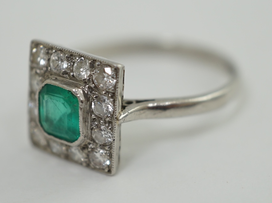 A 1930's/1940's platinum, emerald and diamond cluster set tablet ring